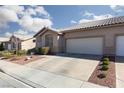 Attractive single-story house with a two-car garage, nestled in a desert-landscaped environment at 214 Roxborough St, Henderson, NV 89074