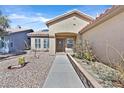 Inviting front entrance with a tiled roof, desert landscaping, and a sidewalk leading to the front door at 3514 Jordan Ln, North Las Vegas, NV 89032