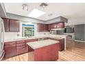 Bright kitchen features dark cabinetry, a skylight, and a center island at 3696 Monte Verde St, Las Vegas, NV 89121