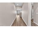 Inviting hallway with archway, light tan paint, and wood-look floors at 4116 Free Bird Crest Ave, North Las Vegas, NV 89081