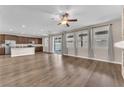 Spacious living room featuring wood floors, neutral walls, and modern ceiling fan at 4116 Free Bird Crest Ave, North Las Vegas, NV 89081