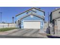 Charming blue two-story home featuring a well-kept lawn and a spacious two-car garage at 4260 E Cincinnati Ave, Las Vegas, NV 89104