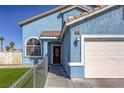 Charming blue two-story home featuring a well-kept lawn, front yard, and a spacious two-car garage at 4260 E Cincinnati Ave, Las Vegas, NV 89104