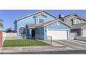 Charming blue two-story home featuring a well-kept lawn and a spacious two-car garage at 4260 E Cincinnati Ave, Las Vegas, NV 89104