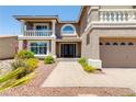 Charming home featuring a three-car garage, desert landscaping, and a brick walkway to the main entrance at 4542 Grey Spencer Dr, Las Vegas, NV 89141