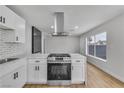 Modern kitchen with stainless steel appliances, and white cabinetry at 4769 Via Renaldo, Las Vegas, NV 89103