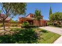 View of home with tile roof, manicured green lawn, and desert landscaping at 5101 Breakers Ln, Las Vegas, NV 89113