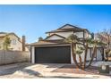 Inviting two-story home with a well-kept yard and a spacious driveway leading to a two-car garage on a clear day at 5825 Bent Branch Ln, Las Vegas, NV 89142