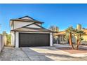 Beautiful single Gathering home featuring a spacious two-car garage, a well-manicured yard, and a sunny front exterior at 5825 Bent Branch Ln, Las Vegas, NV 89142