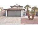 Charming two-story home featuring a well-maintained lawn and two-car garage at 5825 Bent Branch Ln, Las Vegas, NV 89142