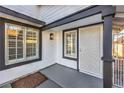 View of the covered front porch with a secure metal security door, white siding, and black accents at 5825 Bent Branch Ln, Las Vegas, NV 89142