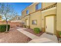 Charming townhome featuring a well-maintained front yard, walkway, and desert landscaping at 6320 Desert Leaf St # 101, North Las Vegas, NV 89081