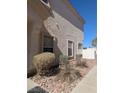 Side view of a home showing windows, stucco exterior, and partial landscaping at 6380 Extreme Shear Ave # 102, Henderson, NV 89011