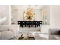 Stylish dining room featuring a modern chandelier and elegant table setting with seating for eight at 8455 Turtle Creek Cir, Las Vegas, NV 89113