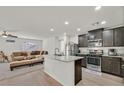 Modern kitchen with granite countertops, stainless steel appliances, and an island at 101 Deseo Ct, North Las Vegas, NV 89031