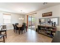 Inviting dining area with a chandelier, sliding glass doors to the backyard, and a stylish display shelf at 10355 Sipple St, Las Vegas, NV 89141