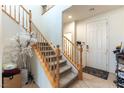 Bright entryway featuring a staircase with wooden banister and a tiled floor, leading to the upper levels of the home at 10355 Sipple St, Las Vegas, NV 89141