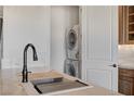 Kitchen with stainless steel sink and a view of the washer and dryer at 1150 Calcione Dr, Henderson, NV 89011