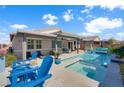 Backyard pool with tanning shelf, covered patio, and mountain views at 181 Sierra Alta Pl, Henderson, NV 89015