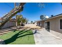 Spacious backyard featuring a combination of concrete patio and artificial grass at 2004 Burnham Ave, Las Vegas, NV 89104