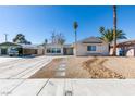 Charming single-story home with rock landscaping and a covered parking space at 2004 Burnham Ave, Las Vegas, NV 89104