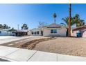 Charming single-story home with rock landscaping and a covered parking space at 2004 Burnham Ave, Las Vegas, NV 89104