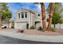 Two story home features an attached garage and xeriscaped front yard at 2504 Cove Rd, Las Vegas, NV 89128