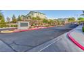 An elegant stone community sign marks the entry to Alta Fiore, featuring a landscaped entrance and stately homes at 26 Lilla Rosa St, Henderson, NV 89011