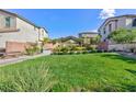 A green community park offers a gazebo, manicured shrubs, benches, and walking paths, perfect for relaxation and recreation at 26 Lilla Rosa St, Henderson, NV 89011