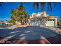 A beautiful view of the home's exterior, showcasing the multi-car garage and well-maintained landscaping at 2638 Douglas Cir, Henderson, NV 89074