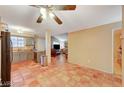 Open floorplan showing the kitchen and living areas with terracotta tile flooring and neutral walls at 2725 S Nellis Blvd # 2179, Las Vegas, NV 89121