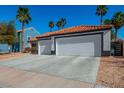 Wide driveway leading to a two-car garage in a single-story residence at 306 Rodarte St, Henderson, NV 89014