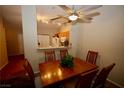 Cozy dining room with wood table, ceiling fan, and kitchen view at 379 Rosado Springs St, Henderson, NV 89014