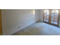 This empty carpeted bedroom has light-filled room with patio access through glass paneled doors at 4055 Nook Way # A, Las Vegas, NV 89103