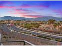 Scenic street view of a residential neighborhood with mountain views, showcasing well-maintained landscaping and community appeal at 4288 Veraz St, Las Vegas, NV 89135