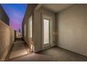 A tidy side yard with a walkway, offering private outdoor space with a modern stucco wall at 472 Sand Dune Arch St, Las Vegas, NV 89138