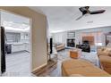 Open concept living space with seamless flow to a modern kitchen and a warm fireplace at 478 Potomac St, Henderson, NV 89015