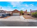 Charming single-story home featuring desert landscaping, a tile roof and an attached two-car garage at 4932 Goldeneye Way, North Las Vegas, NV 89031