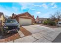 Charming single-story home featuring desert landscaping, a tile roof and an attached two-car garage at 4932 Goldeneye Way, North Las Vegas, NV 89031