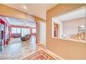 Open-concept living room featuring plush seating, a fireplace, and abundant natural light at 5295 Acqua Ln, Pahrump, NV 89061