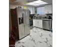 Well-equipped kitchen with modern appliances and white cabinetry with gray countertop at 5939 Vegas Dr, Las Vegas, NV 89108