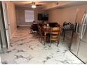 Open living and dining area, featuring tile flooring, a ceiling fan, and modern furnishings at 5939 Vegas Dr, Las Vegas, NV 89108