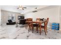 Bright living area with marble-style tile flooring, a ceiling fan, and modern furnishings at 5939 Vegas Dr, Las Vegas, NV 89108