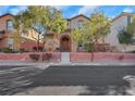 Charming home featuring a stone-accented entrance, landscaped yard, and a welcoming front facade at 7083 Mackenzie Bay Ave, Las Vegas, NV 89179