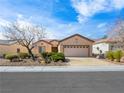 Charming single-story home features a well-manicured front yard and a two-car garage at 7757 Coast Jay St, North Las Vegas, NV 89084