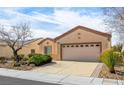 Charming single-story home features a well-manicured front yard and a two-car garage at 7757 Coast Jay St, North Las Vegas, NV 89084