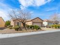 Charming single-story home features a well-manicured front yard and a two-car garage at 7757 Coast Jay St, North Las Vegas, NV 89084