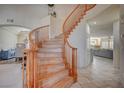 Elegant curved wood staircase leading to the upper level of the home at 7905 Brent Leaf Ave, Las Vegas, NV 89131