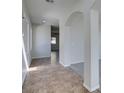 Inviting hallway features tile flooring and arched doorways at 9102 Brilliant Prairie Ct, Las Vegas, NV 89149