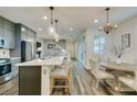 Open-concept kitchen featuring a large island, modern appliances, and a dining area at , Henderson, NV 89015